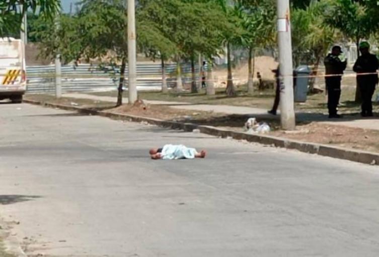 Persona muerta tendida en el piso.